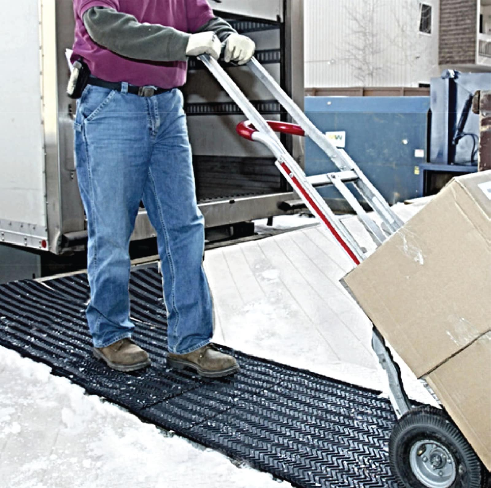 A heated entrance mat being placed for winter service